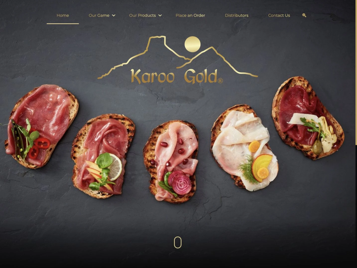 Karoo Gold homepage with its gold mountain logo and five food presentations on a dark textured background